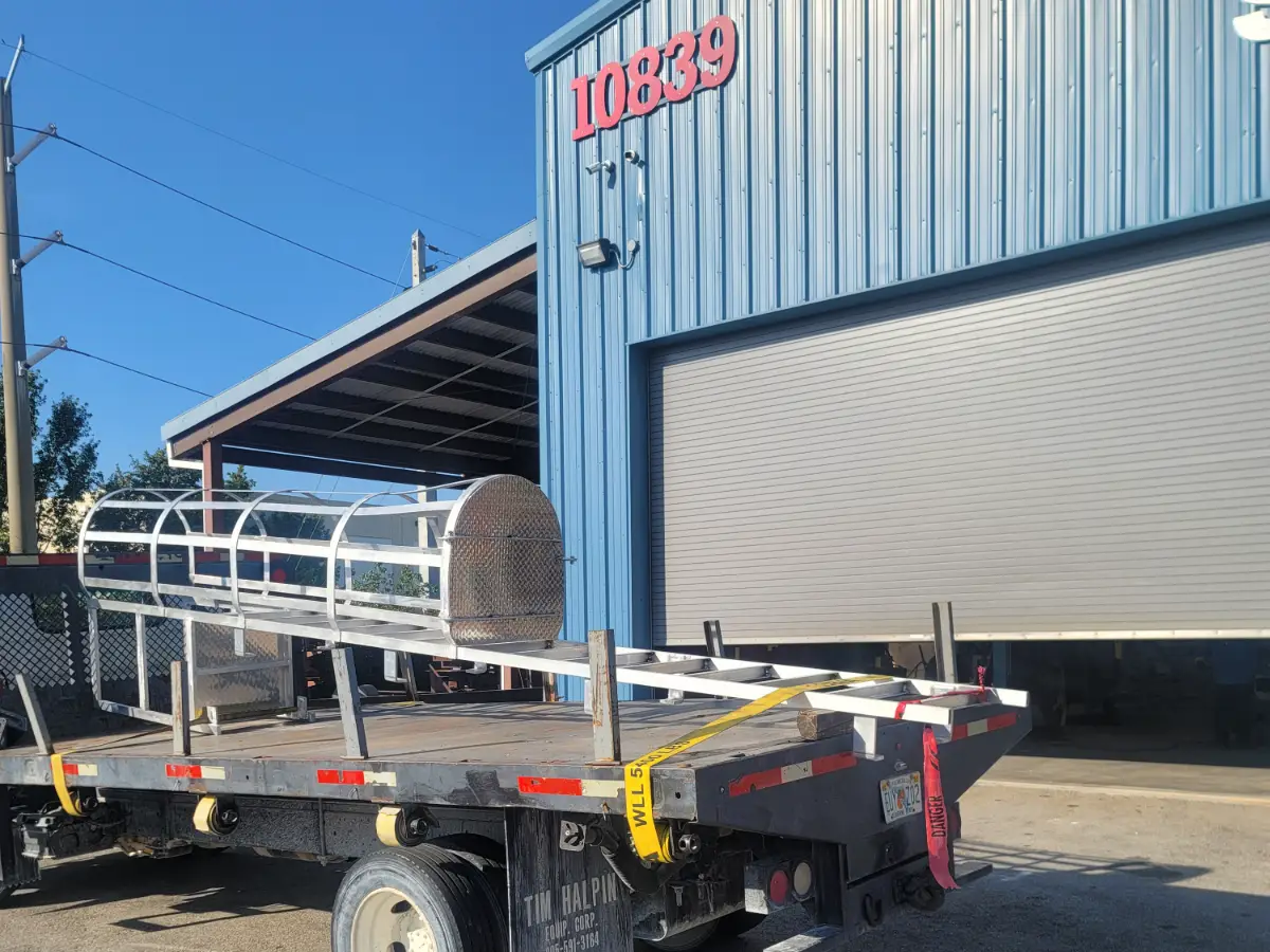 Fabricated aluminum ladder cage loaded for delivery outside the TL Welding shop at 10839 NW 21st St, Miami