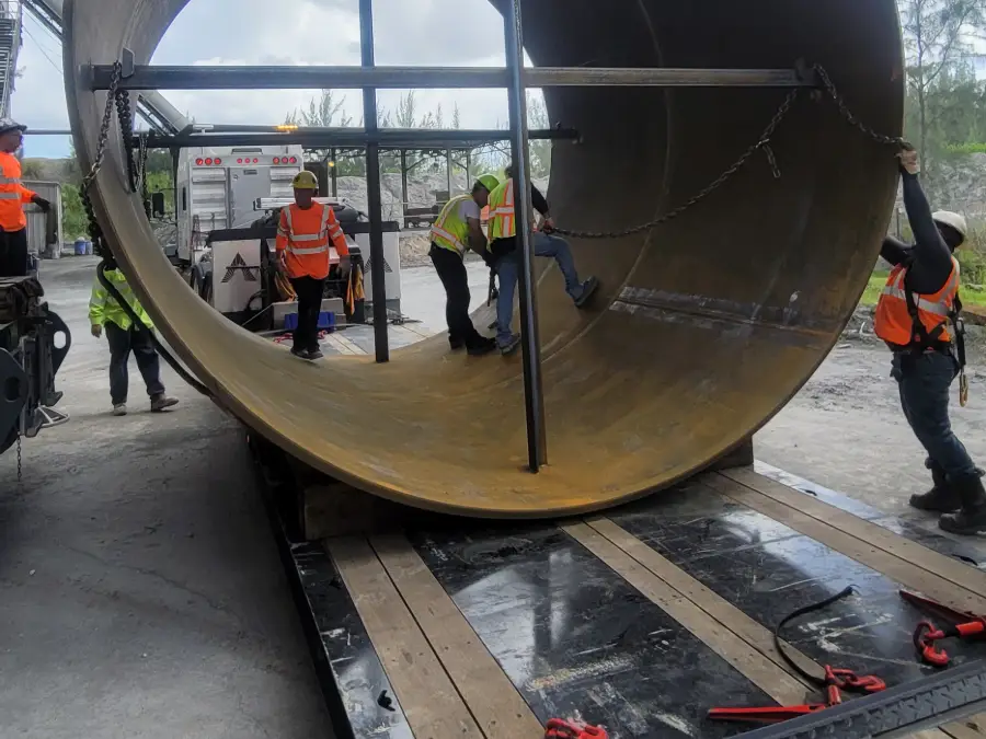 TL Welding field crew fitting a large fabricated steel cylinder on a lowboy trailer
